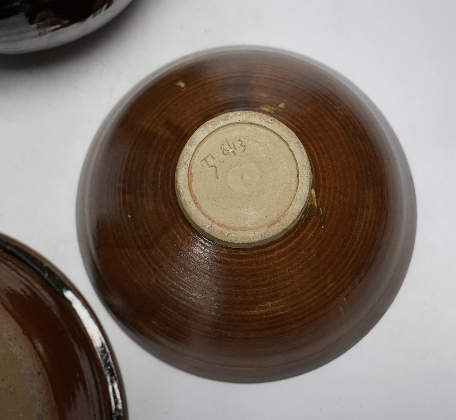 A David Melville studio stoneware pot and cover, a large dish and plate, largest 30cm diameter, a Raku ware pottery vase, a Leiard dish, a dish and a grey glazed vase, Raku vase 17.5cm high. Condition - varies, fair to g